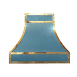 curved matte blue stainless steel island chimney range hood framed with polished brass straps and decorative rivets for luxury farmhouse kitchen design back view