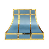 curved matte blue stainless steel range hood framed with polished brass straps and decorative rivets for luxury farmhouse kitchen design