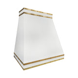 custom white stainless steel range hood with sleek silhouette and brass accents