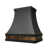 stainless steel kitchen range hood with black finish and brass accents