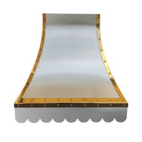 refined curved stainless steel island chimney range hood with polished brass rivet trim and decorative scalloped bottom edge for luxury farmhouse kitchen renovation front view