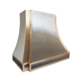 detailed angle showing polished brass accents and brushed stainless steel surface of modern kitchen range hood