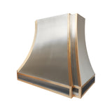 detailed angle showing polished brass accents and brushed stainless steel surface of modern kitchen range hood