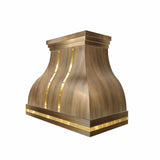 antique brass range hood with polished brass straps and rivets