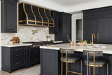 industrial stainless steel range hood with brushed finish and brass accents
