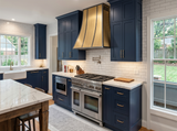 wall mount brass range hood in farmhouse kitchen