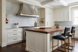 stainless steel vent hood with brass accents used in modern kitchen